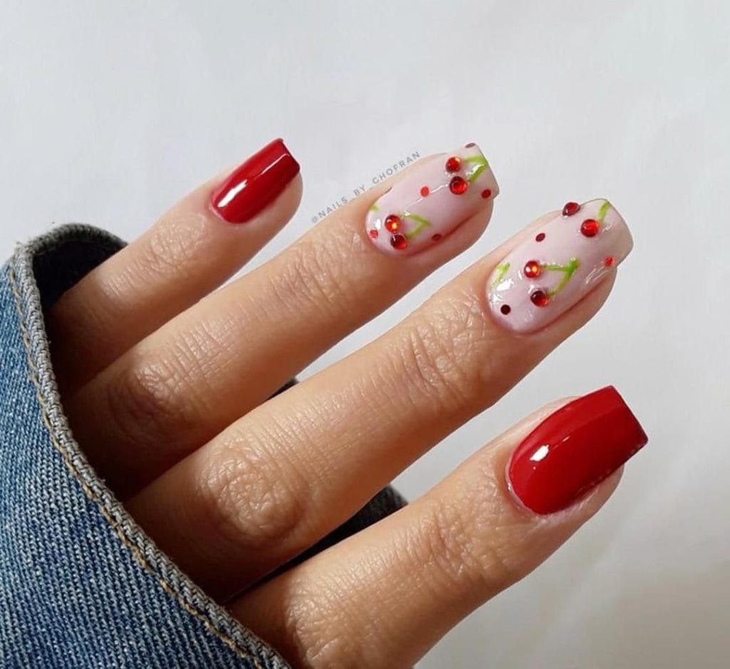 Red nails with 3D cherry gems and milky pink base 