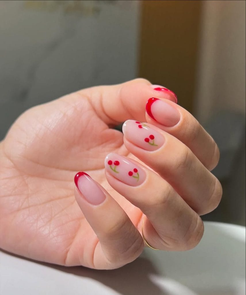 Classic red french manicure with minimal cherry design 