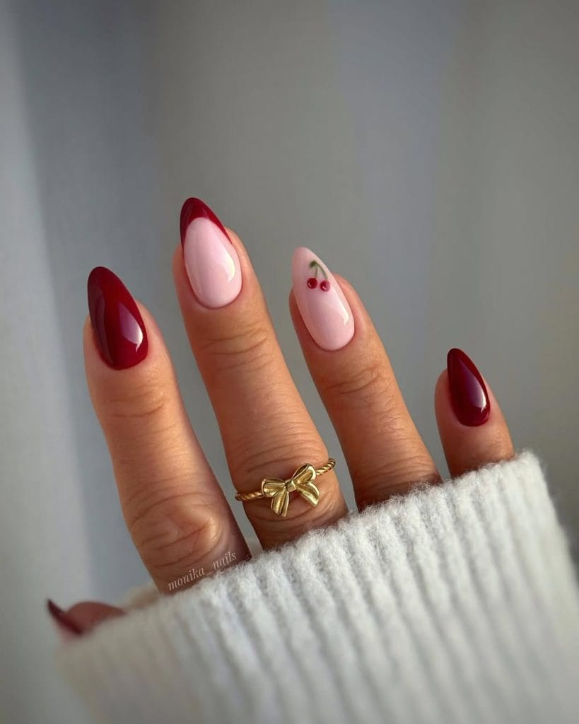 Dark burgundy and sheer pink almond nails with red cherry art 