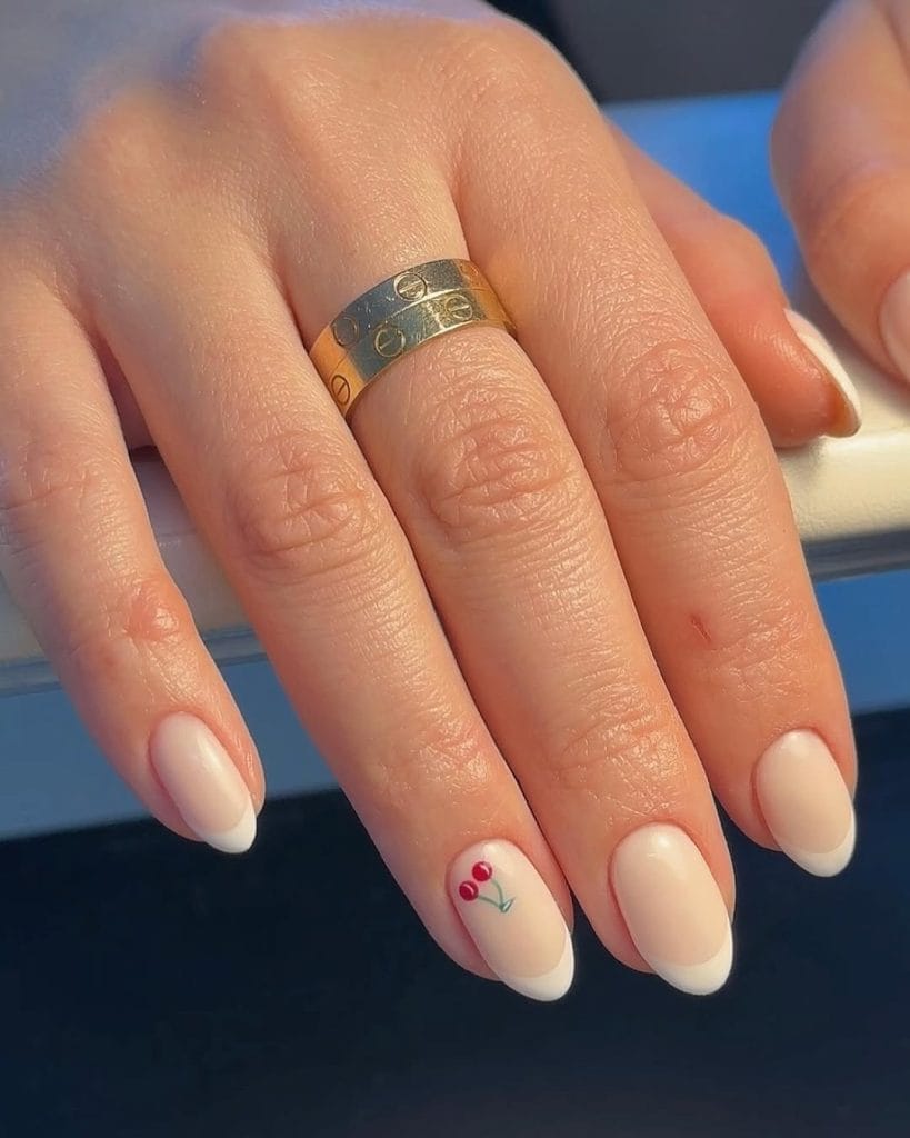 Classic French manicure with minimal cherry accent nail
