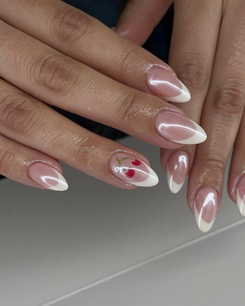 Almond shaped white French nails with cherry design
