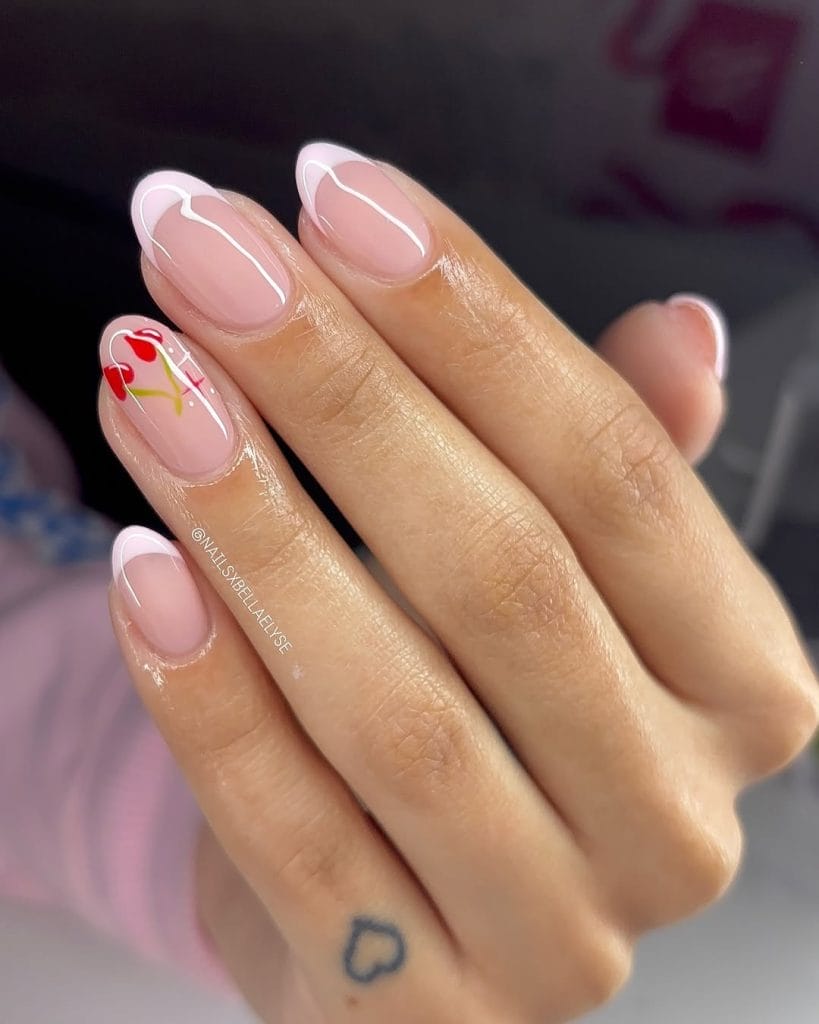 Modern French nails with white tips and cherry detail
