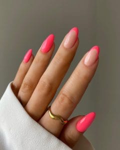 Long oval July nails with mix of nude base hot pink French tips and solid hot pink nails