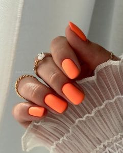 Short square July nails with bright coral orange matte finish polish