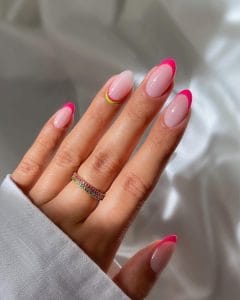 Long almond July nails with milky white base, hot pink French tips, and watermelon design accent at the cuticle of one nail