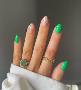 Short oval summer nails with bright green and pink mix featuring green accent stripes and solid green nails