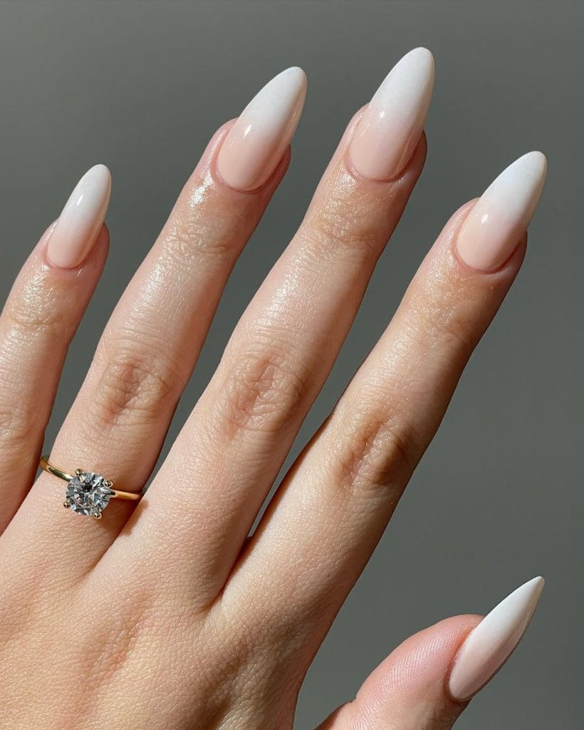  Nude to white ombre neutral nails on long almond shape with gradient effect
