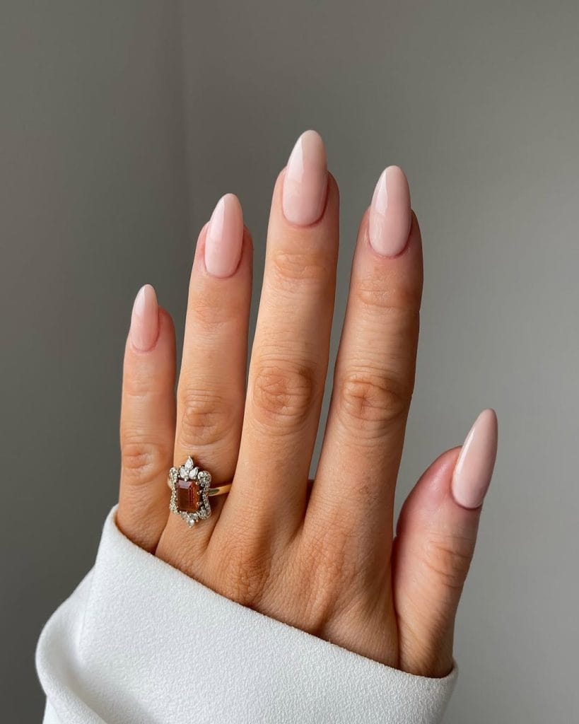 Milky nude neutral nails on oval shape with creamy finish