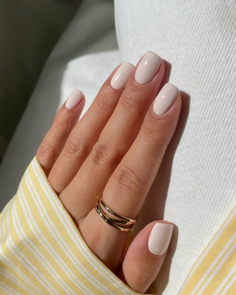 Creamy white neutral nails on squoval shape with glossy finish
