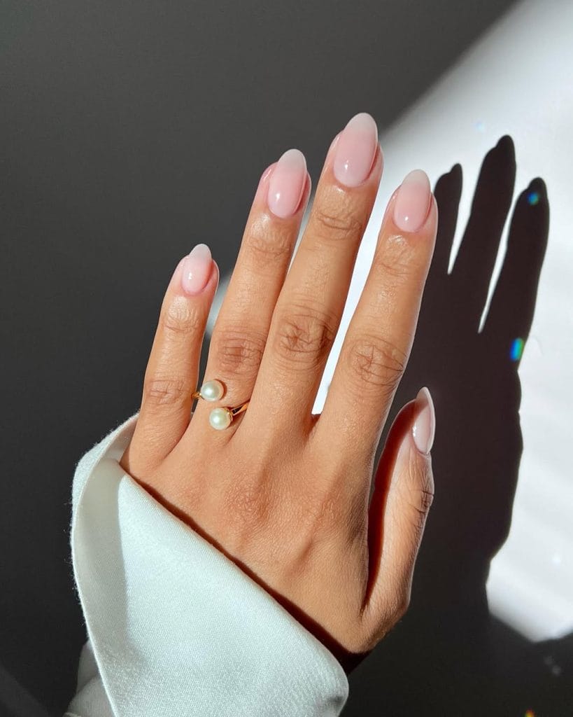 Sheer milky pink neutral nails on medium oval shape with translucent finish
