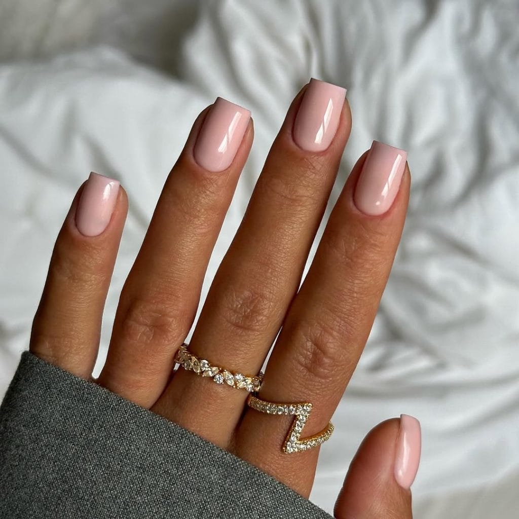 Beige pink neutral nails on short square shape with glossy finish
