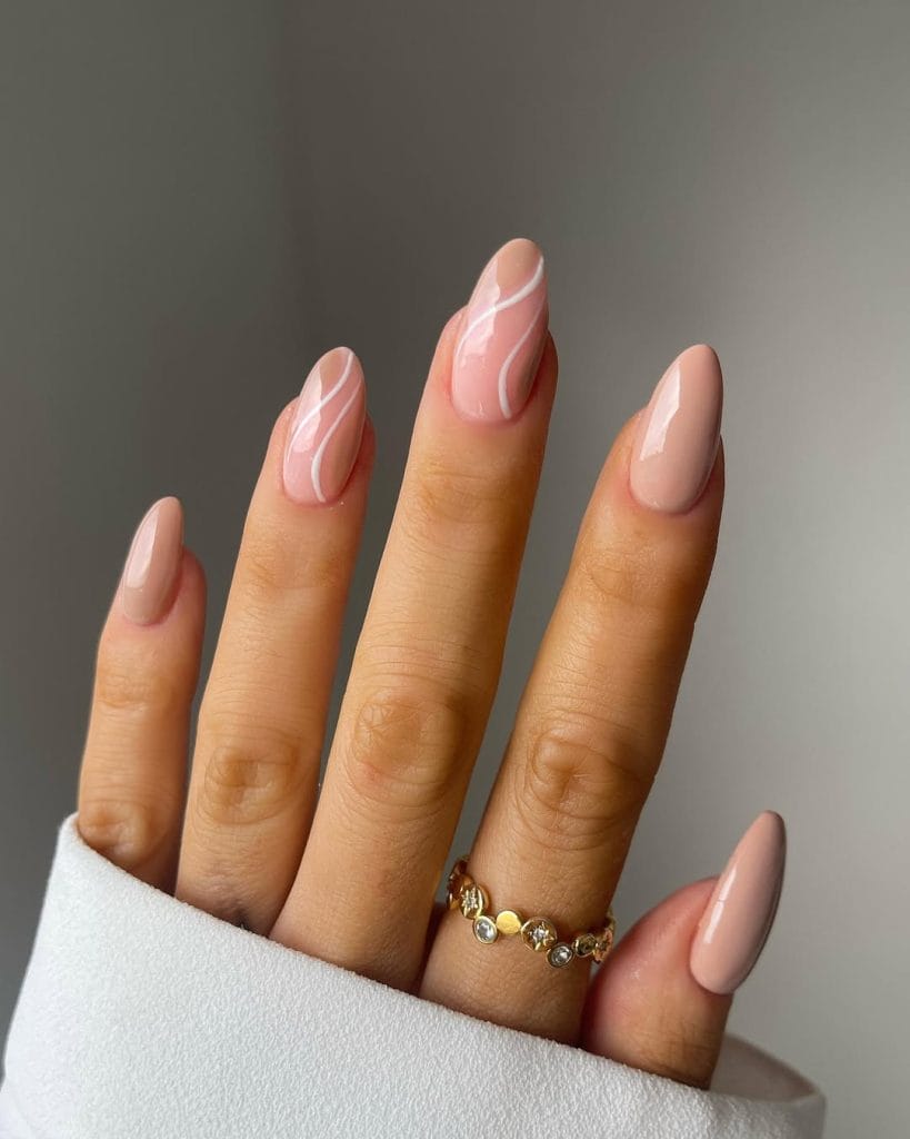 Nude swirl art neutral nails on oval shape with graphic line design