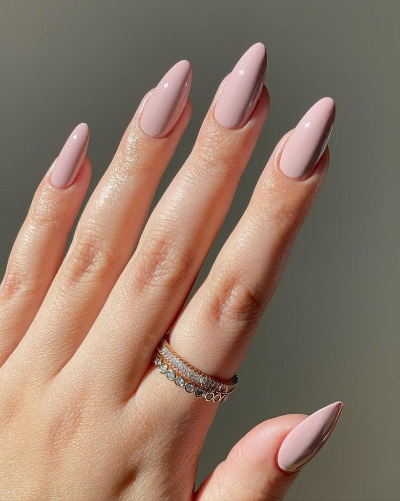 Dusty rose neutral nails on long almond shape with glossy finish